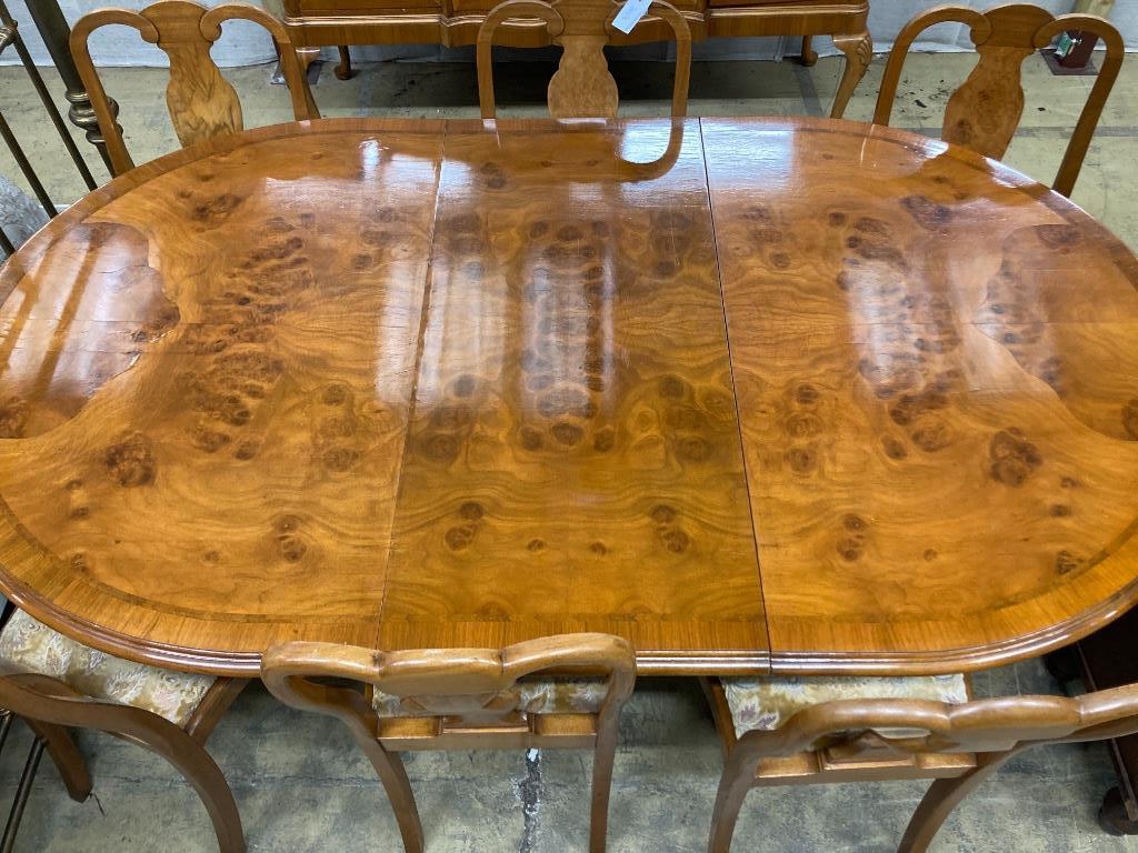 A Berwick Furniture Queen Anne Revival walnut dining suite, comprising a sideboard, an extending twin pillar dining table and six chairs, sideboard width 154cm depth 54cm height 90cm